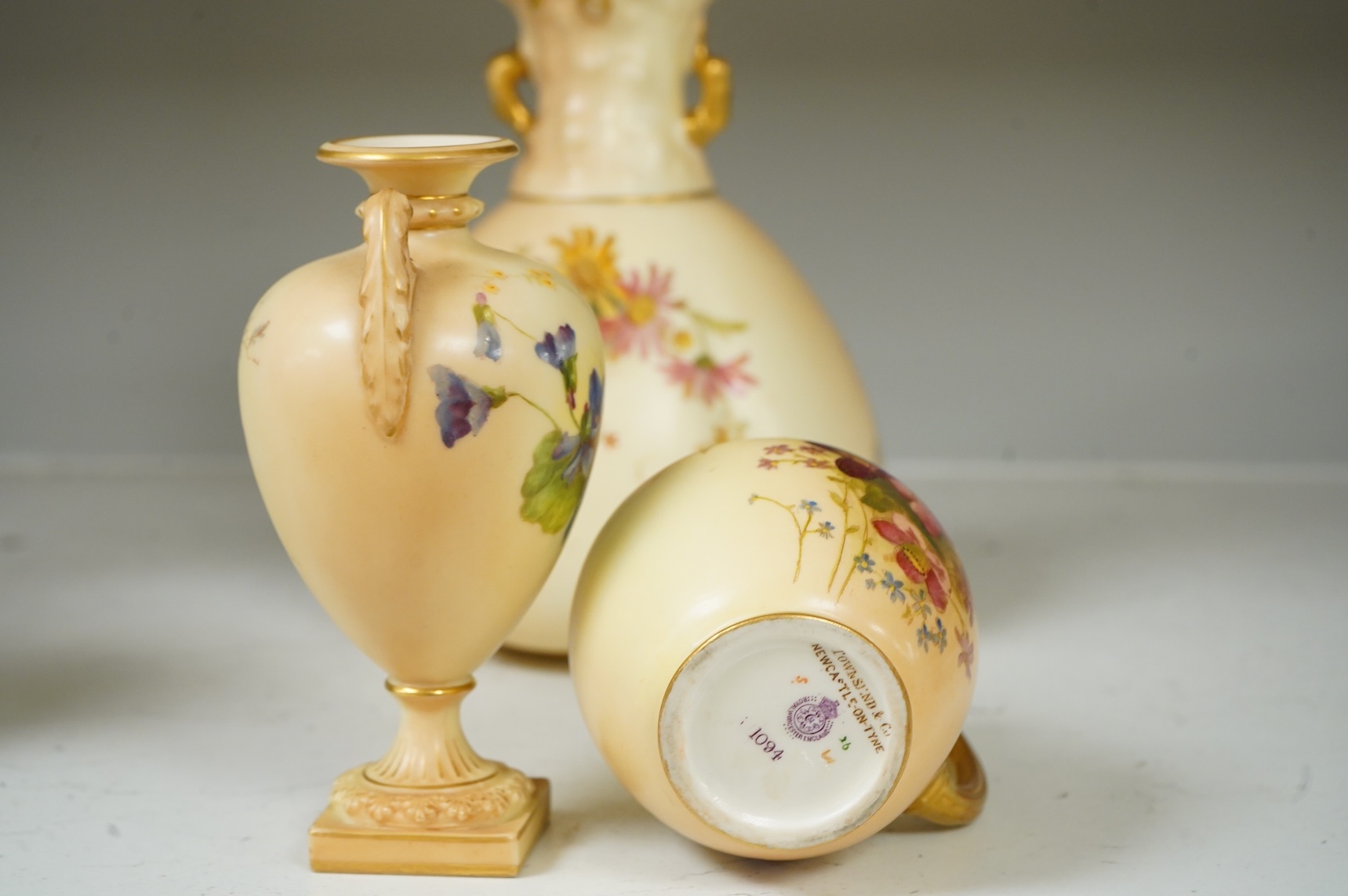 Three pieces of Royal Worcester blush ivory porcelain vessels, tallest 20cm